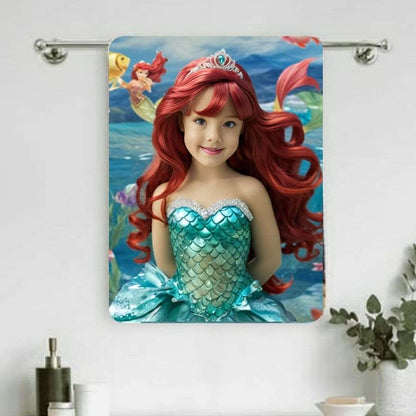 Example of how to upload a girl's photo to create a personalized mermaid portrait on a towel featuring her as a mermaid sitting on a rock in an underwater scene