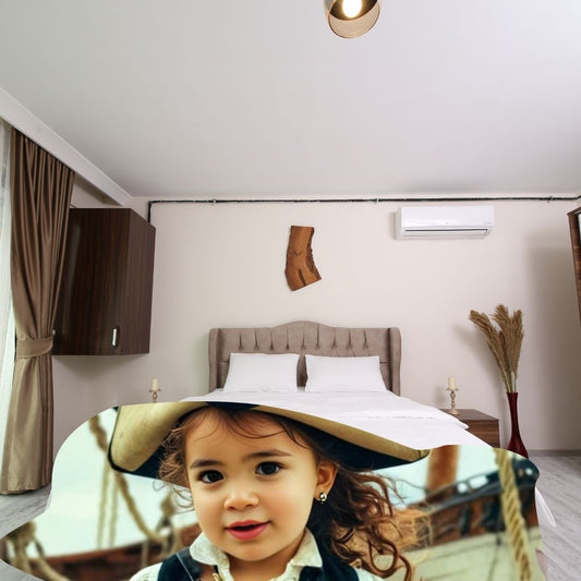 Example of how to upload a toddler girl's photo to create a personalized pirate portrait on a blanket featuring her dressed as a pirate on a ship deck