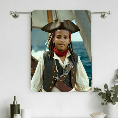 Example of how to upload a boy's photo to create a personalized pirate portrait on a towel featuring him dressed as a pirate on a ship deck.