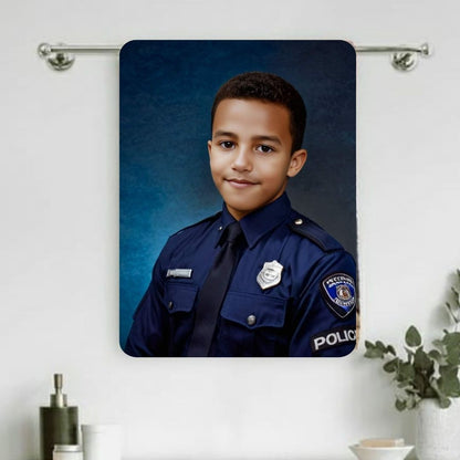 Example of how to upload a boy's photo to create a personalized police officer portrait on a towel, featuring him dressed as a police officer, standing proudly in front of a police car