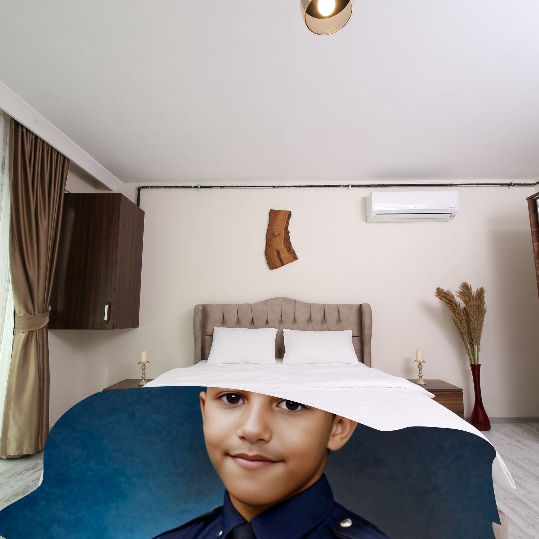 Example of how to upload a boy's photo to create a personalized police officer portrait on a blanket featuring him dressed as a police officer, standing proudly in front of a police car.